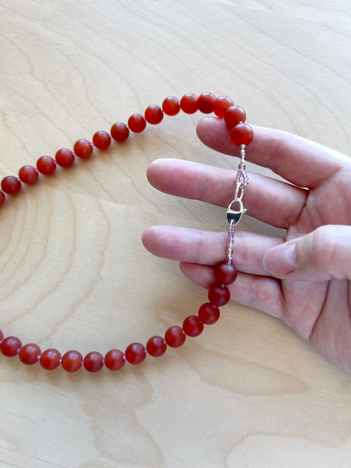 BD. Necklace of Carnelian with a matte finish and sterling silver lobster claw clasp 18”