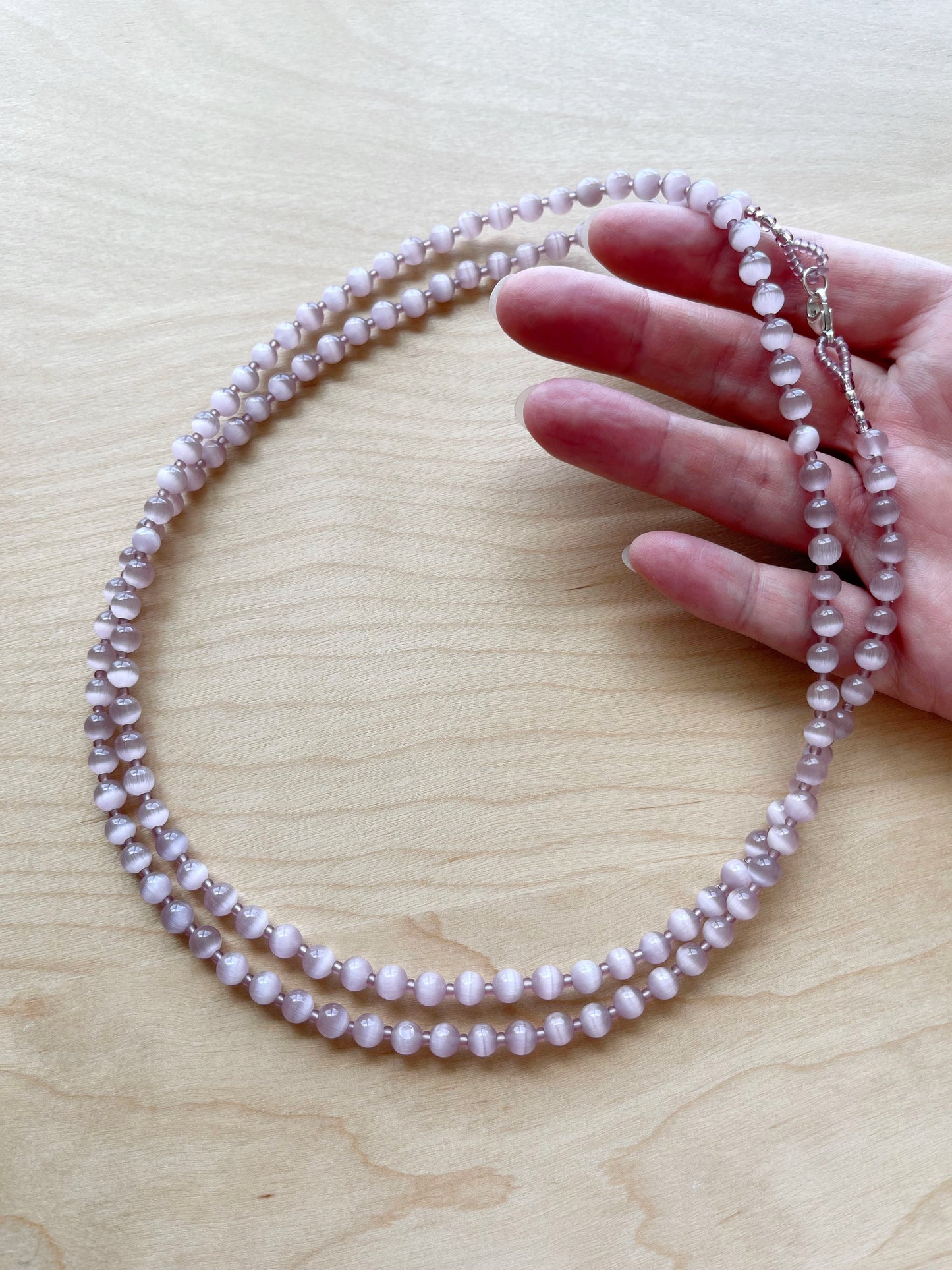 B. 38” Long & double-able necklace of Mauve Cat’s Eye Glass